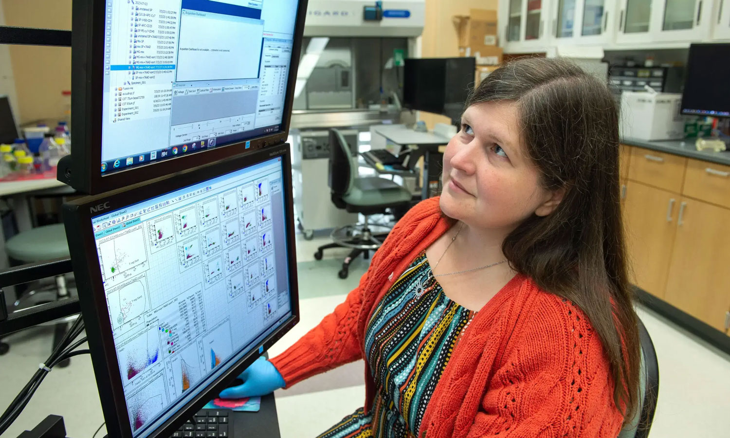 Rebecca Martin, Ph.D., looking at two computer screens