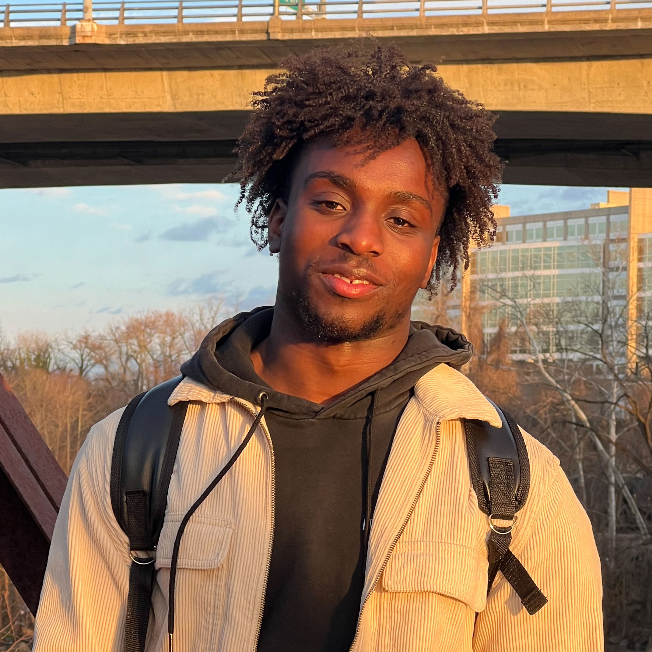 Darrell Otoo outside standing in front of a highway overpass