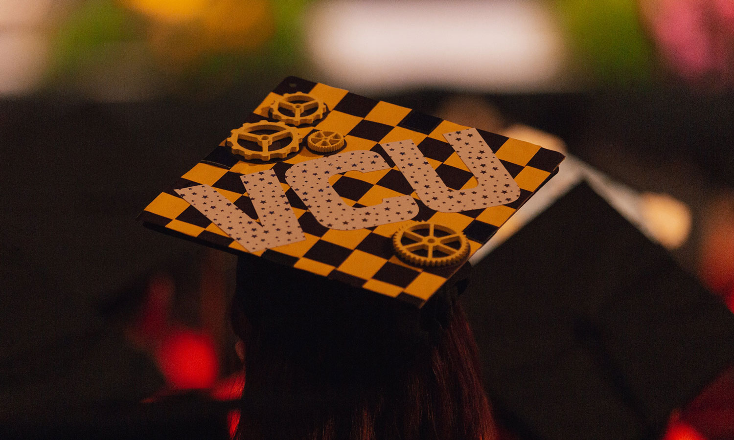 Student's graduation cap with VCU and gears on it