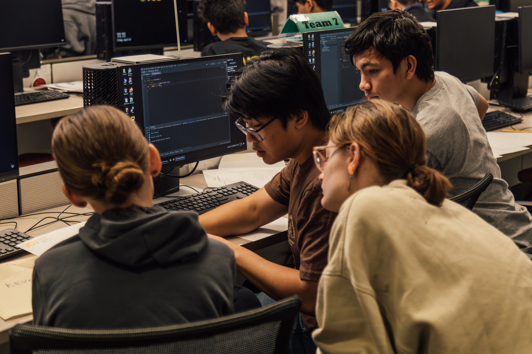 A group of students coding in a computer lab