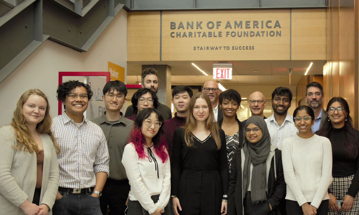 A group of students standing in front of the Bank of America Stairway to Success
