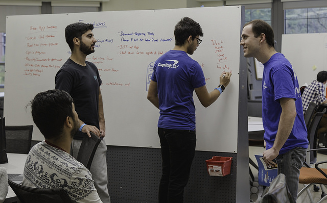 Students working in front of a whiteboard at Power the Future in Oct. 2018