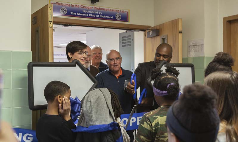 Principal Michael Powell cuts the ribbon on the new Distance Learning Lab at John B. Cary Elementary School, funded by the Kiwanis Club of Richmond.