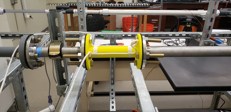 This yellow heat transfer enhancement tube contains twisted tape components that spin fluids to increase turbulence and improve heat transfer. Because it was 3D printed, it is 