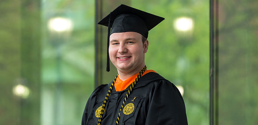 Computer Science student Brandon Watts in cap and gown