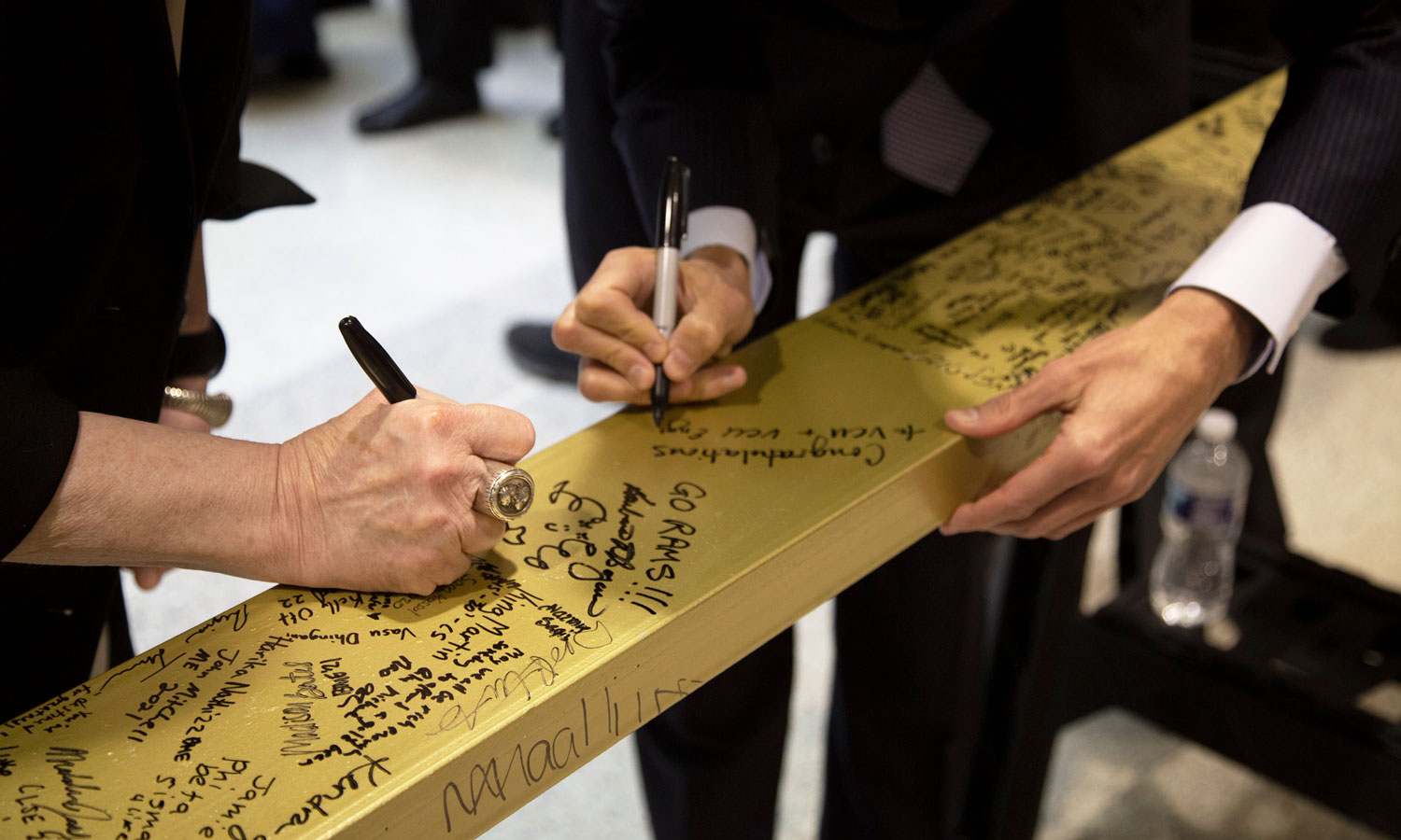 Dean Boyan and VCU president Michael Rao signing the beam