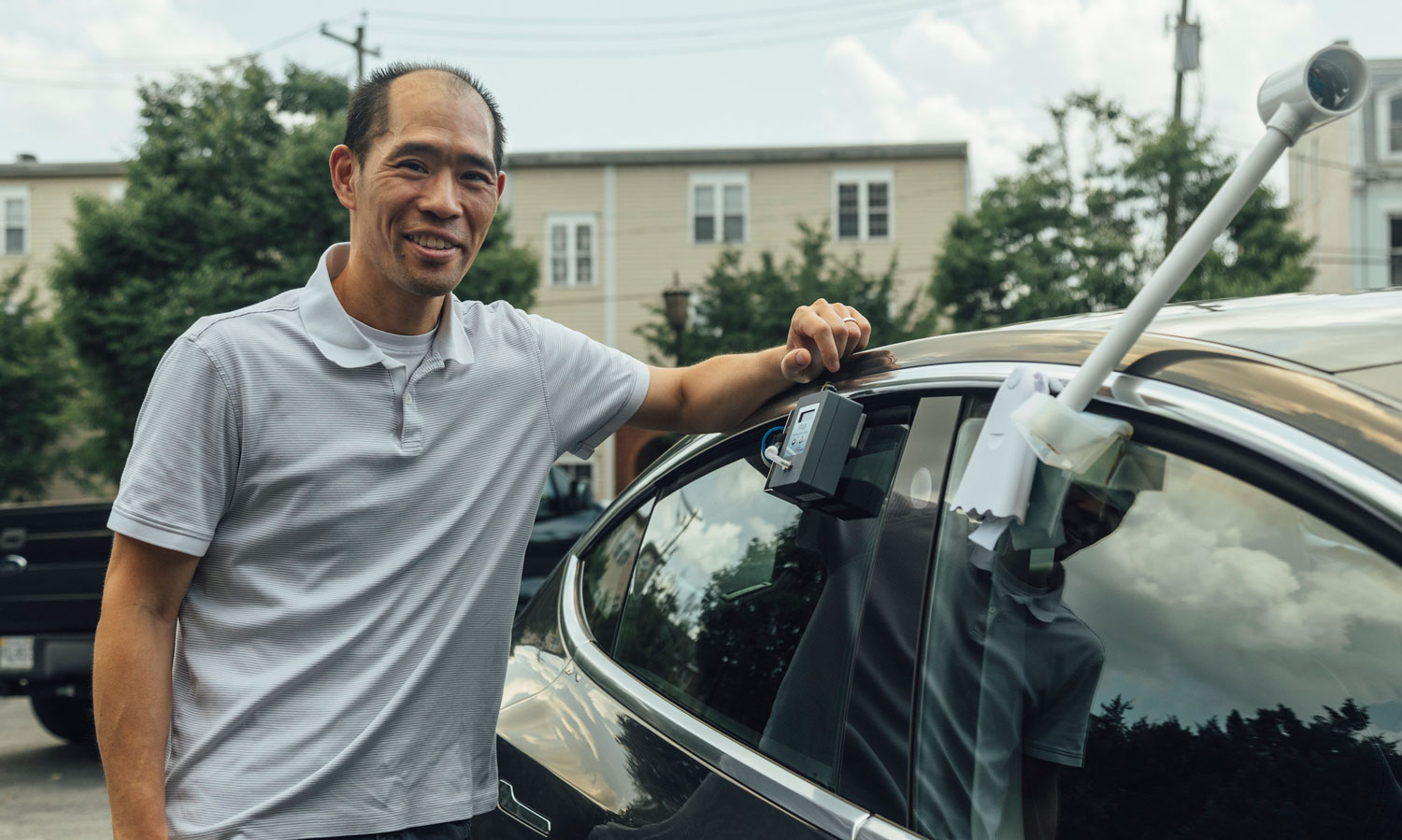 VCU College of Engineering chemical and life science engineering professor Stephen S. Fong, Ph.D, affixes a monitor to measure local ozone pollution on his car.