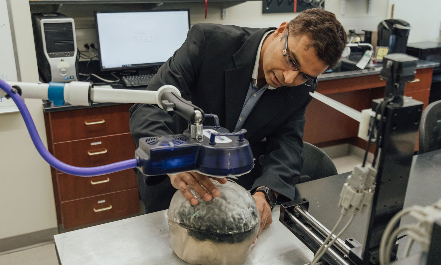 Ravi Hadimani, Ph.D., working with a brain phantom device