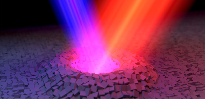 A film of doped oxide material is pumped with an ultraviolet (blue) and near infrared (red) laser beams