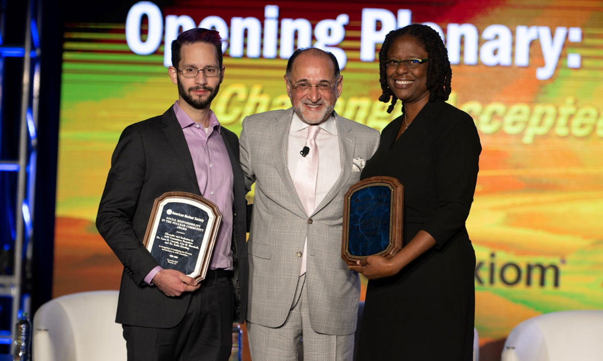 Lane Carasik, Ph.D., mechanical and nuclear engineering assistant professor, (left) and Lisa Marshall (right) are presented with the Social Responsibility in the Nuclear Community Award from the American Nuclear Society.