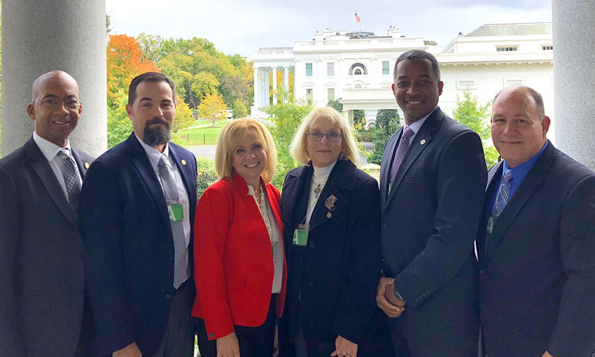 From left: Van Wilson, Ph.D., Tina Manglicmot, Ph.D., Sue Magliaro, Ph.D., Gregory Triplett, Ph.D., and Al Byers, Ph.D.. The White House is in background.