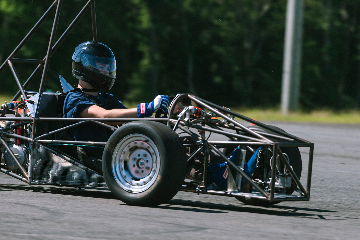 A male student driving a prototype race car